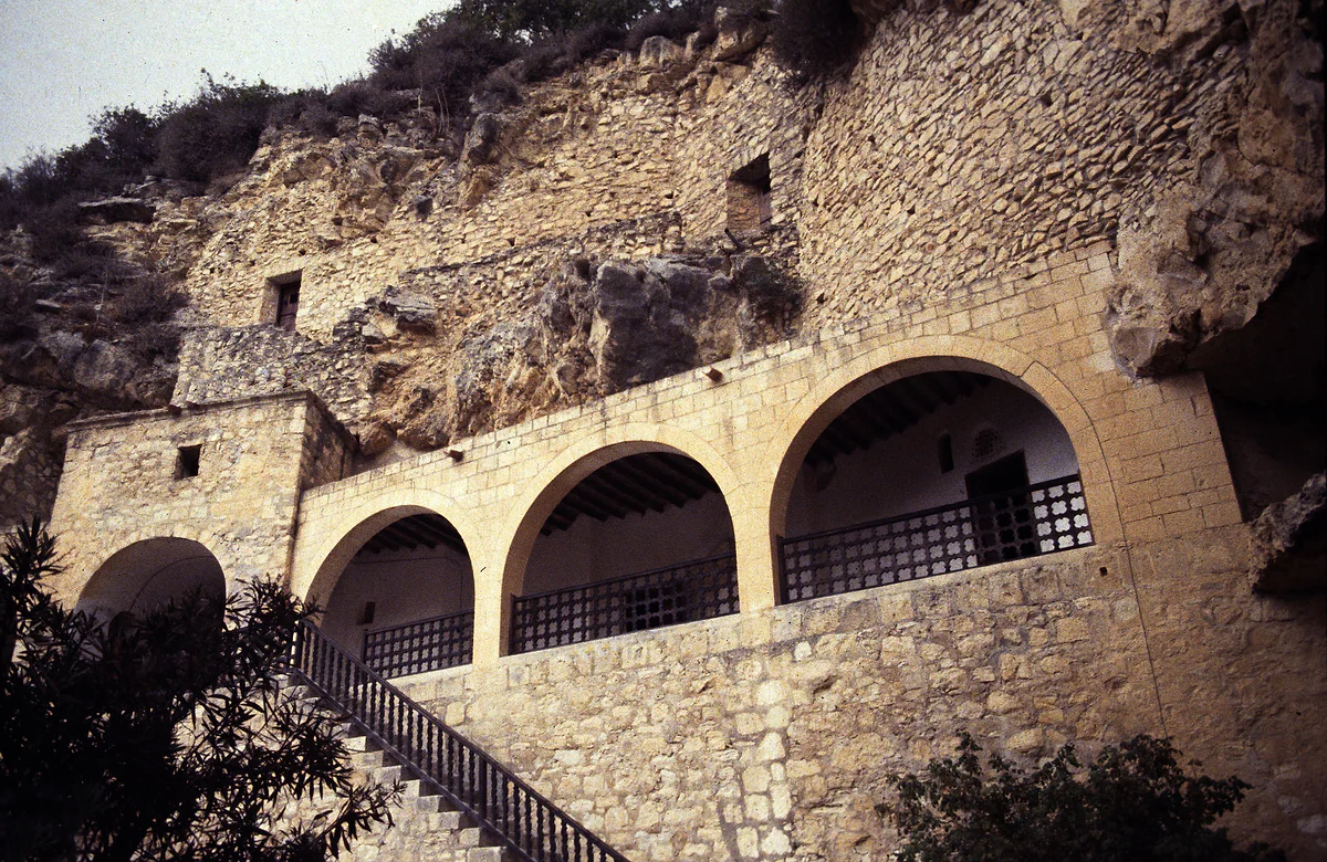 The Enkleistra of Agios Neophytos, cells carved into the rock above an arched gallery and a stone stairway, near Tala, Cyprus
