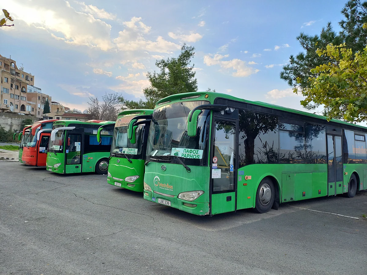 Green intercity buses parked at the bus station in Paphos, part of the network linking the towns of Cyprus