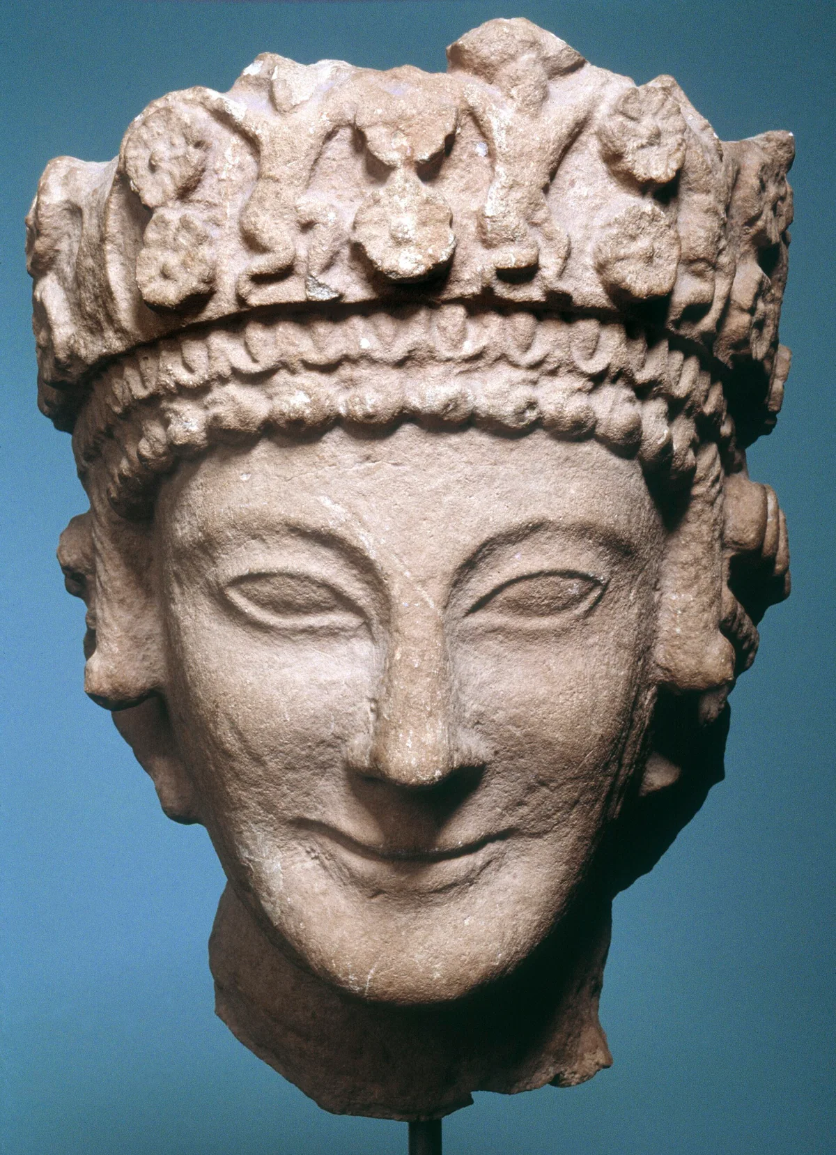 The Vouni head, a female sculpture wearing a tall diadem decorated with dancing figures and rosettes, found at Vouni