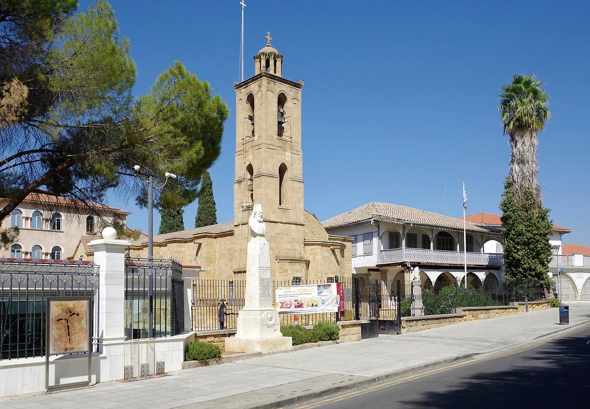 St John's Cathedral in Nicosia, built of stone with a bell tower, beside the Archbishop's Palace under a blue sky