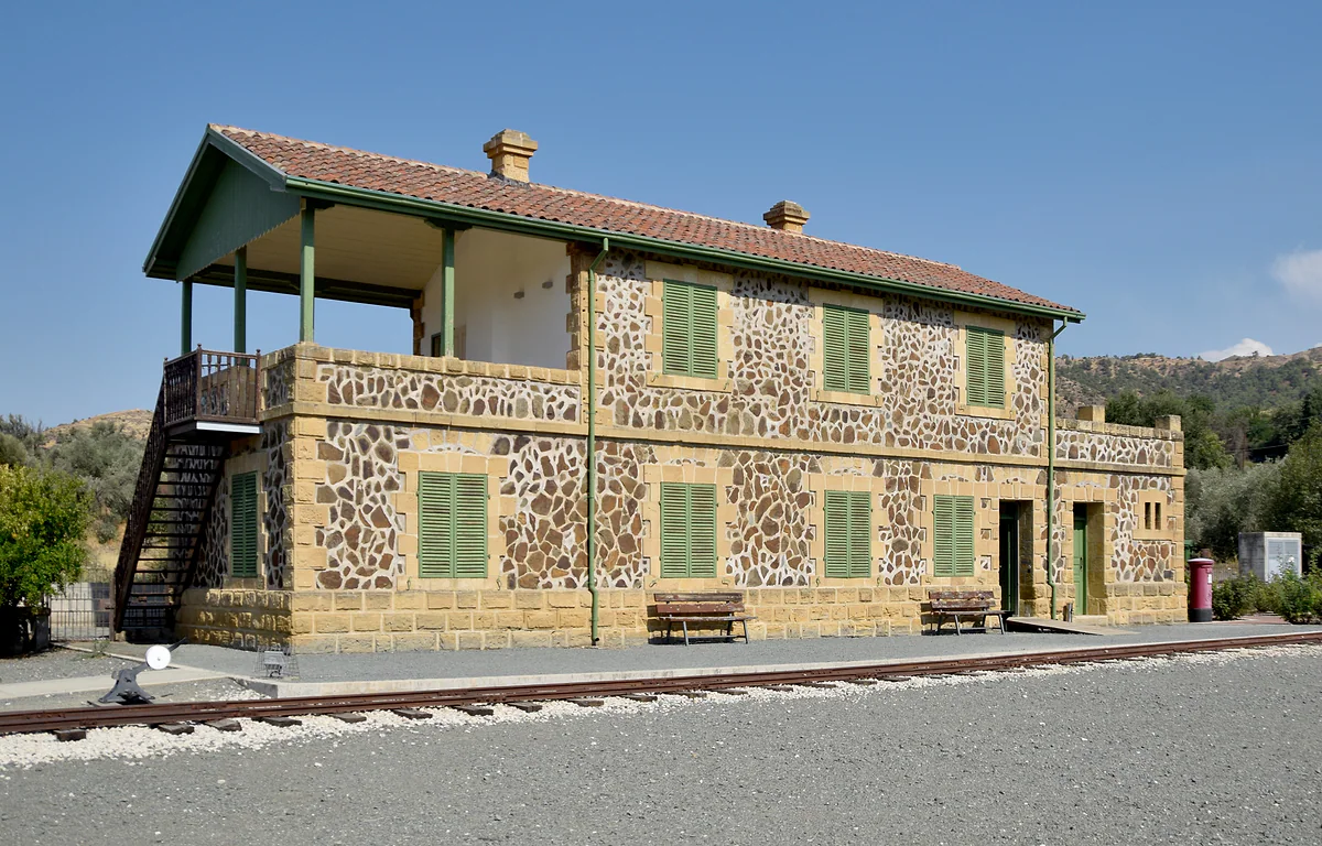 The old Evrychou railway station, in stone with green shutters, now the Cyprus Railway Museum with a stretch of track