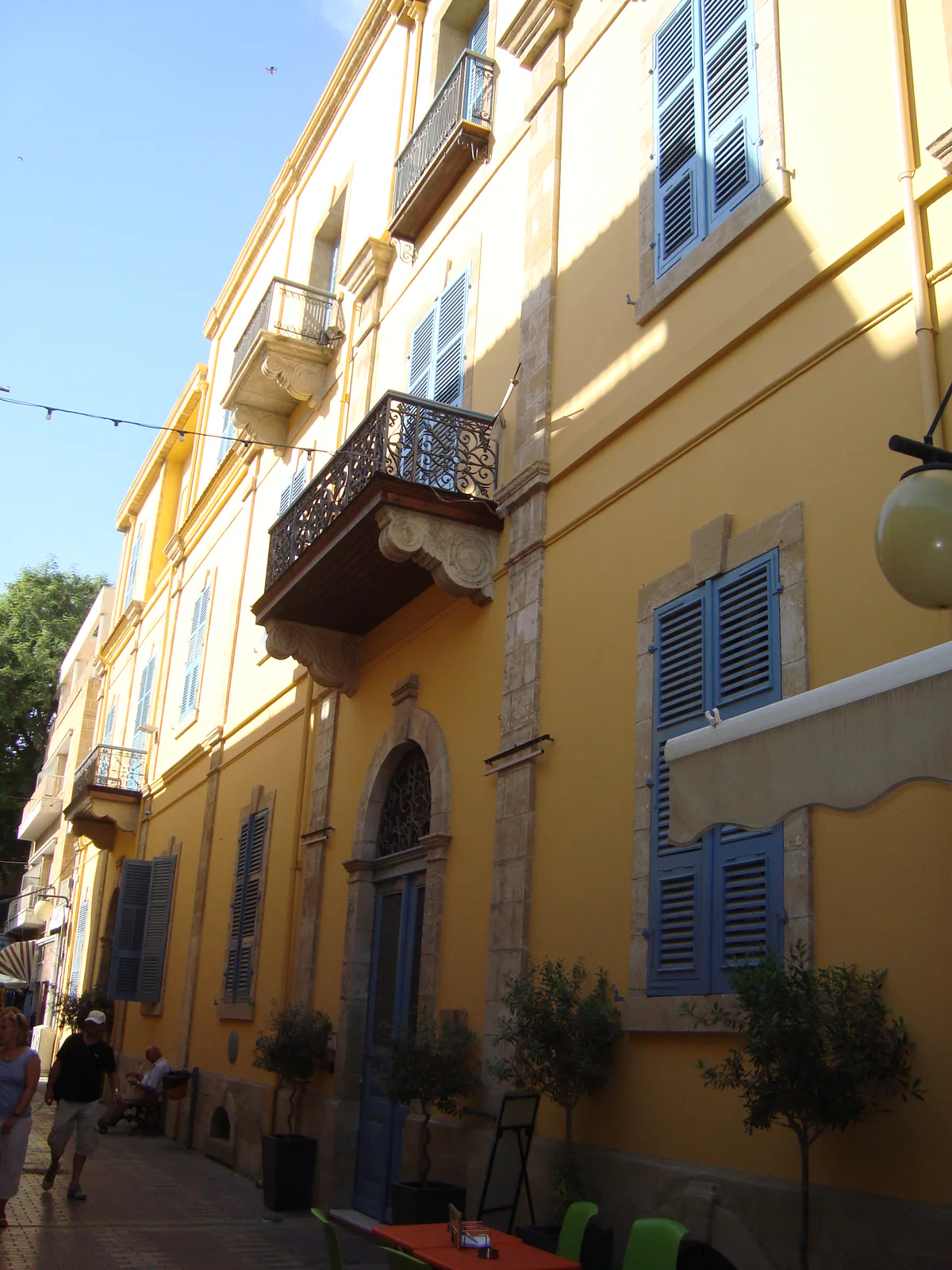 The yellow façade of the Leventis Municipal Museum in Nicosia, a town mansion with balconies and blue shutters