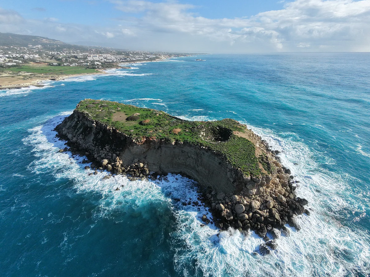 Yeronisos island seen from the air off the cape at Agios Georgios in Pegeia, with the Paphos district coastline behind it