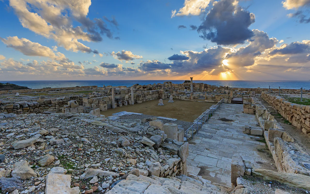 The remains of the early Christian basilica at Kourion at sunset, with fallen columns and the sea on the horizon