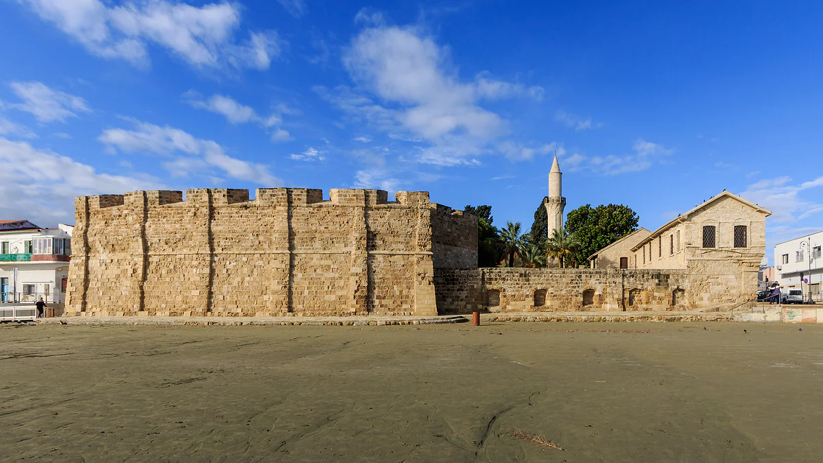 Larnaca's medieval fort, with massive crenellated stone walls, and the minaret of the Kebir mosque rising behind it