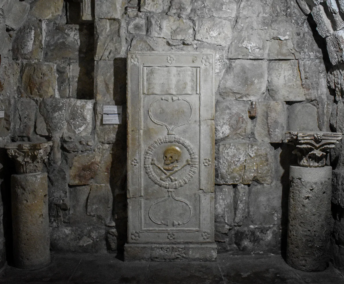 A stone funerary slab carved with a skull, set between two columns in one of the rooms inside Limassol Castle