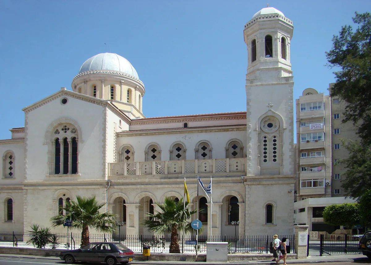 The Orthodox cathedral of Agia Napa in Limassol, with its dome, the bell tower and palm trees in front of the façade