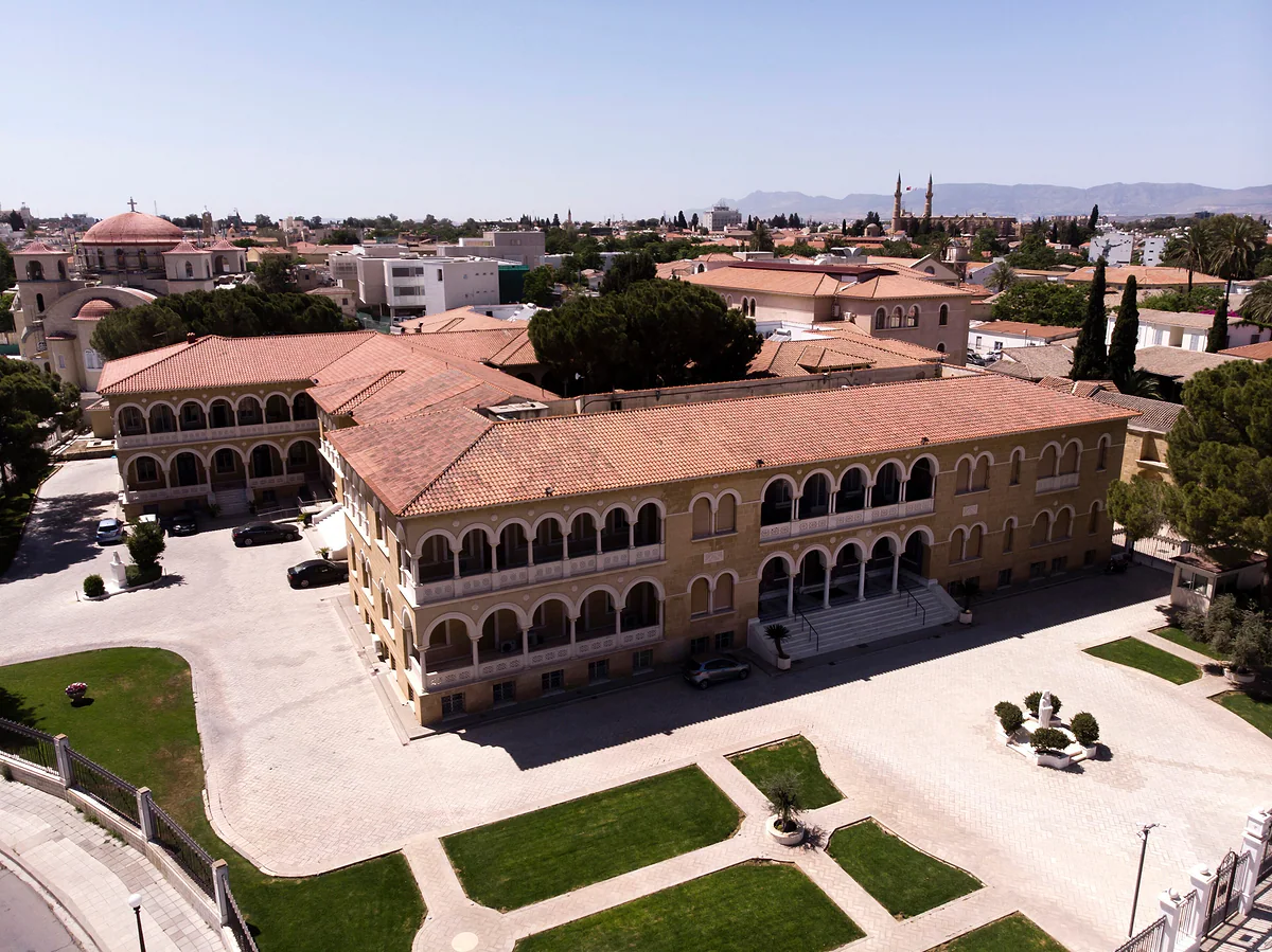The Archbishop's Palace complex in Nicosia seen from above, with its red roofs, courtyards and the old town around it