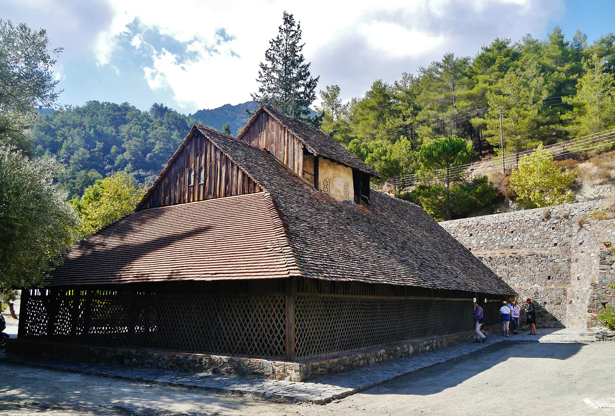 Panagia tou Araka near Lagoudera, with its huge timber roof sweeping down almost to the ground and pine trees around it