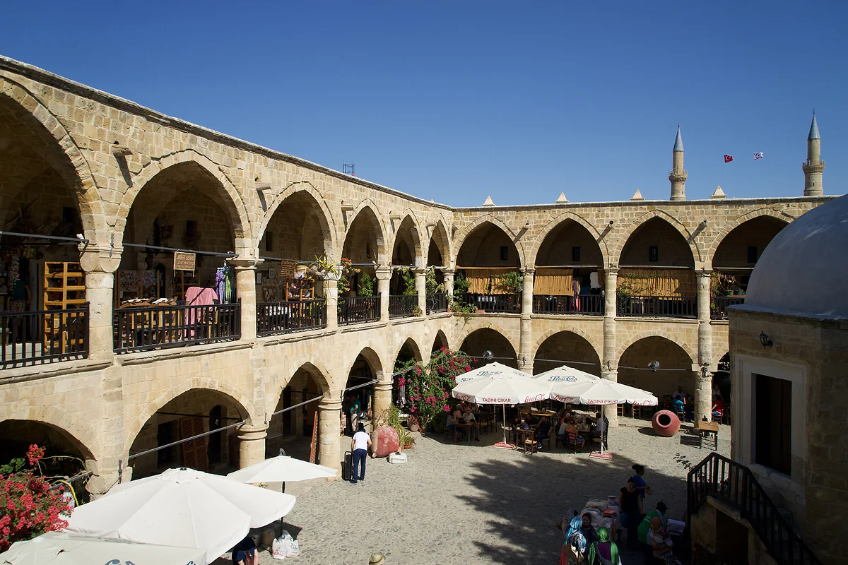 The courtyard of the Büyük Han in North Nicosia, a two-storey arcaded Ottoman caravanserai with a small mosque at its centre