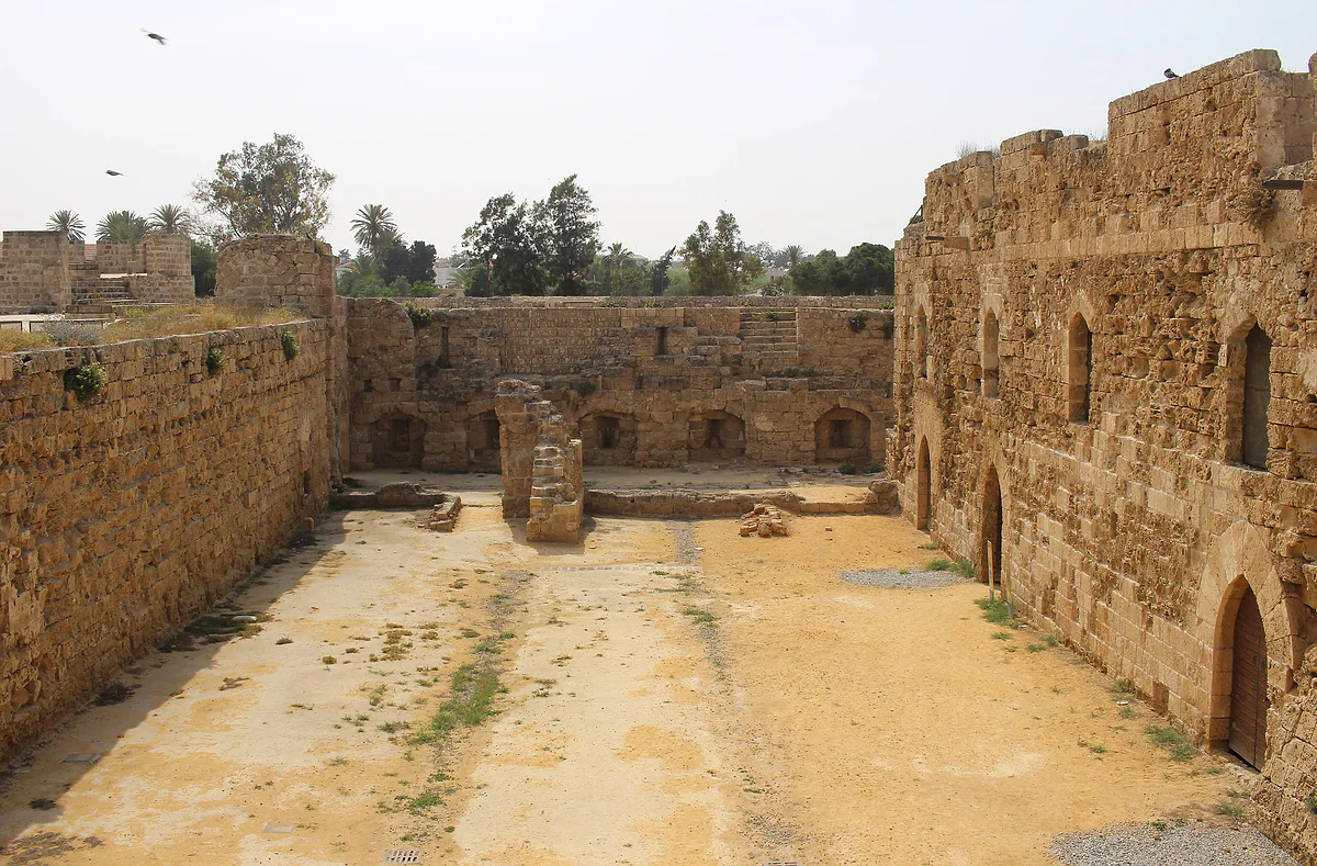 The inner courtyard of Othello Tower in Famagusta, with stone walls, pointed arches and windows of the Lusignan hall