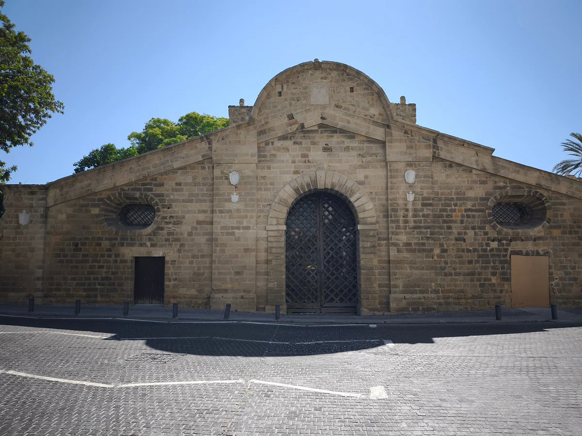 The stone façade of the Famagusta Gate in Nicosia, with its large wooden door flanked by two round windows