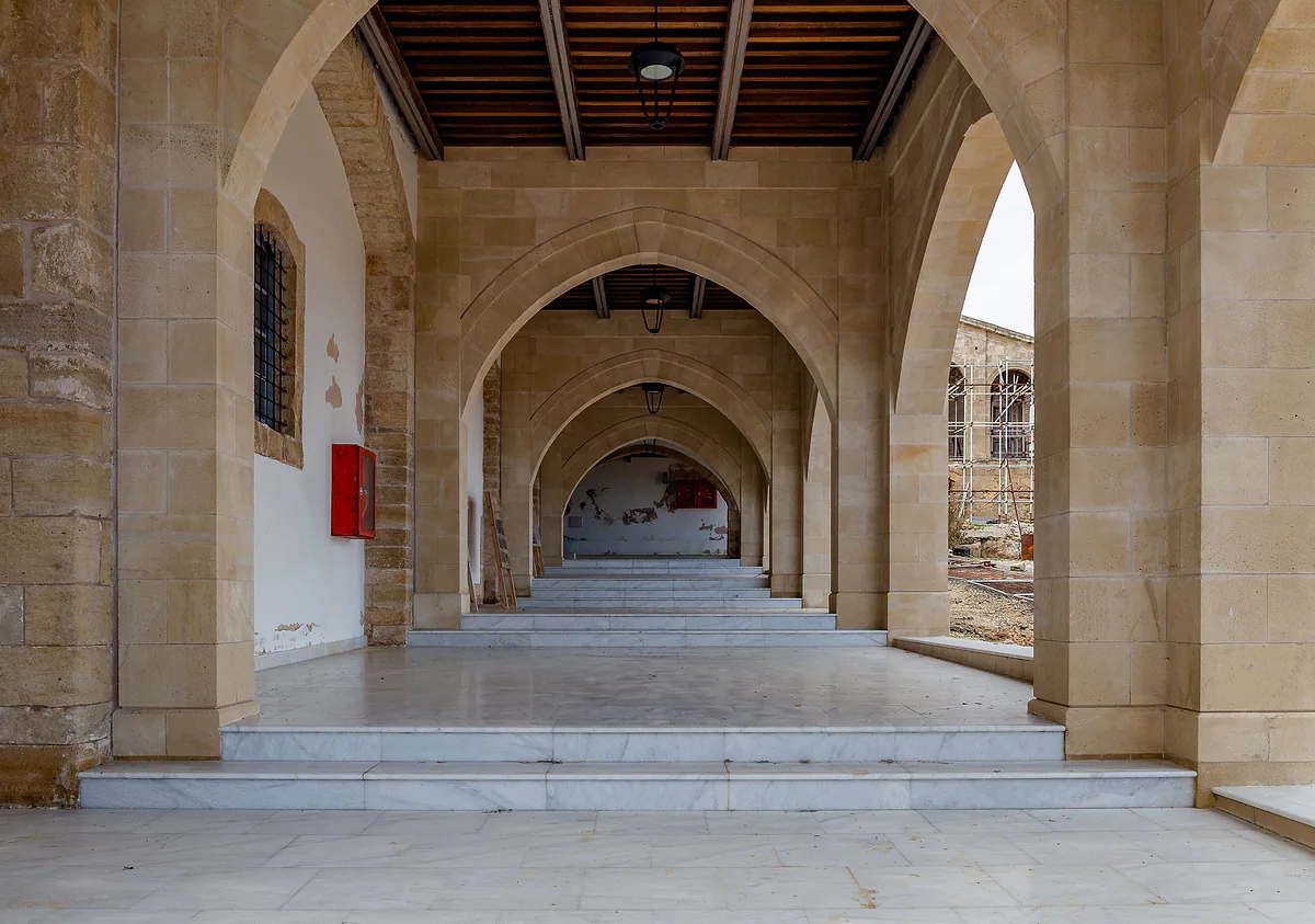 The stone arcades of Apostolos Andreas Monastery, at the tip of the Karpas Peninsula, with a marble floor underfoot