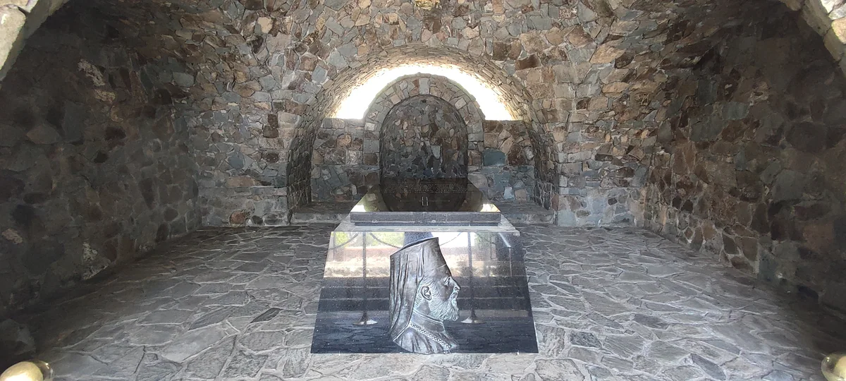 Archbishop Makarios's tomb at Throni, a stone vaulted chamber holding the slab and his portrait in relief, near Kykkos
