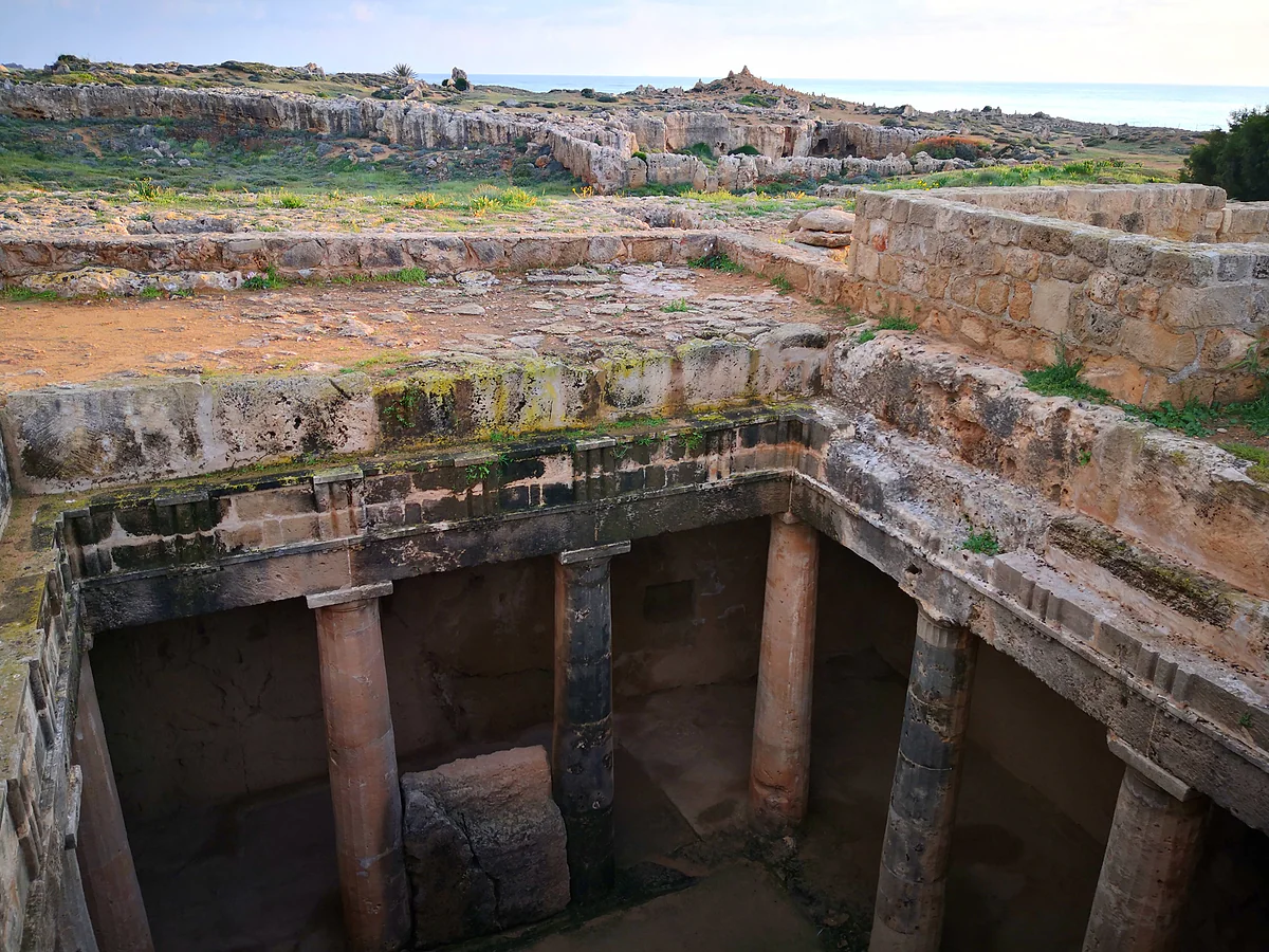 The columned courtyard of one of the main tombs at the Tombs of the Kings in Paphos, carved into the rock below ground level