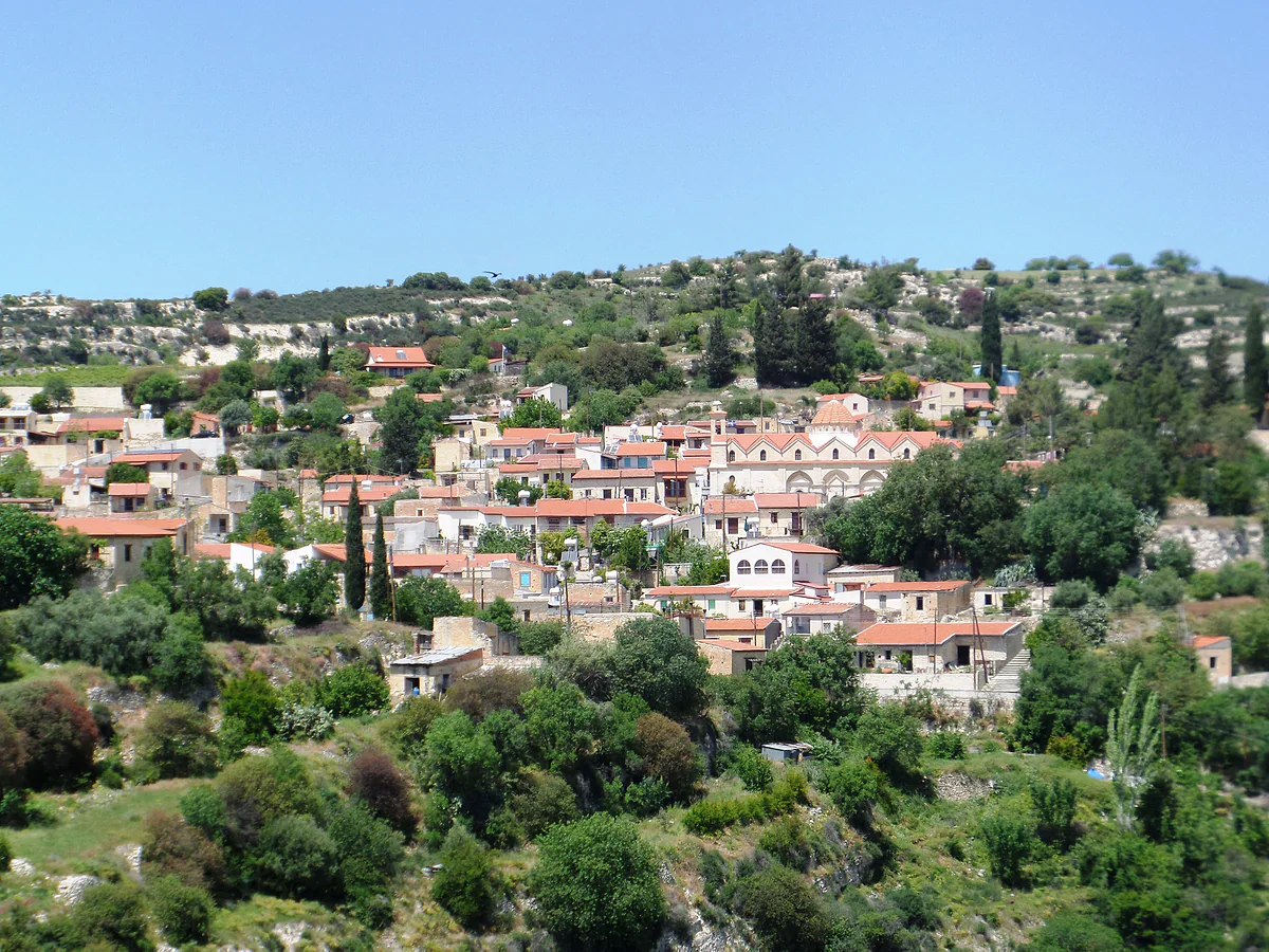 Vasa Koilaniou on its slope, pale stone houses and red roofs among cypresses, orchards and vines of the Krasochoria