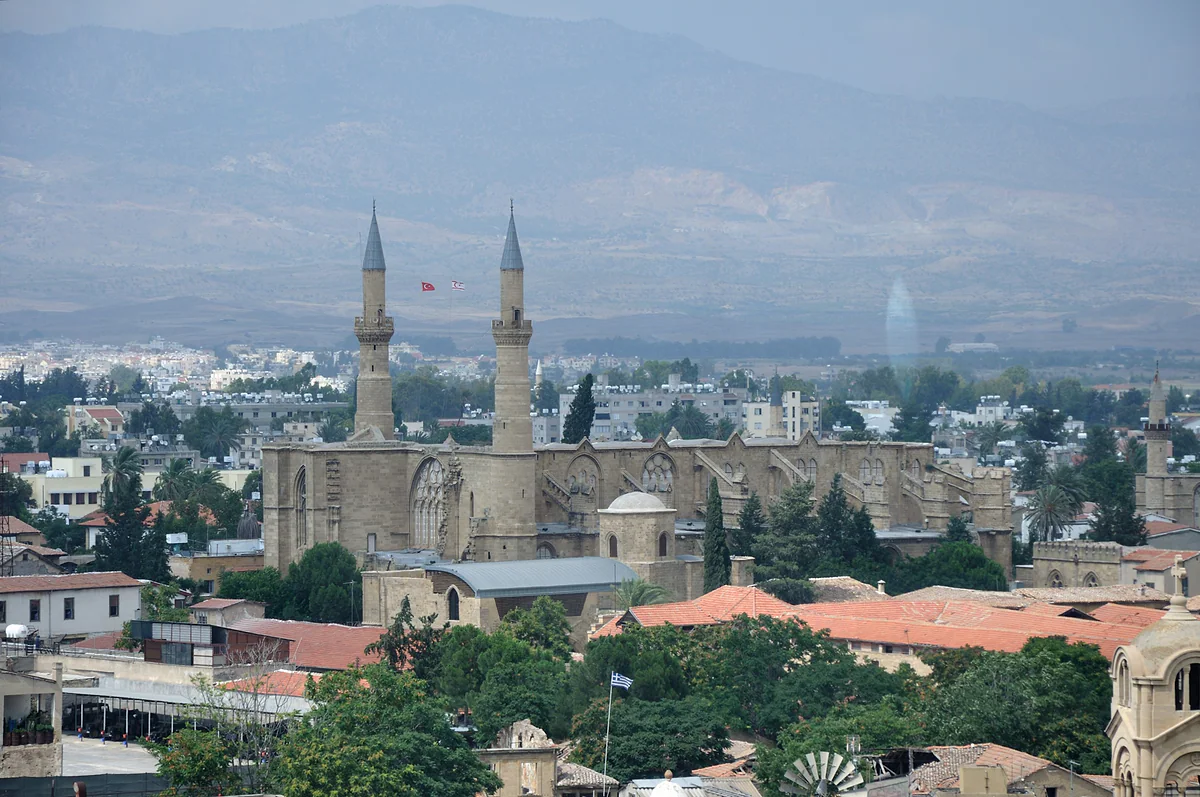 Nicosia seen from the Shacolas Tower, with the twin minarets of the Selimiye Mosque and the Kyrenia range behind