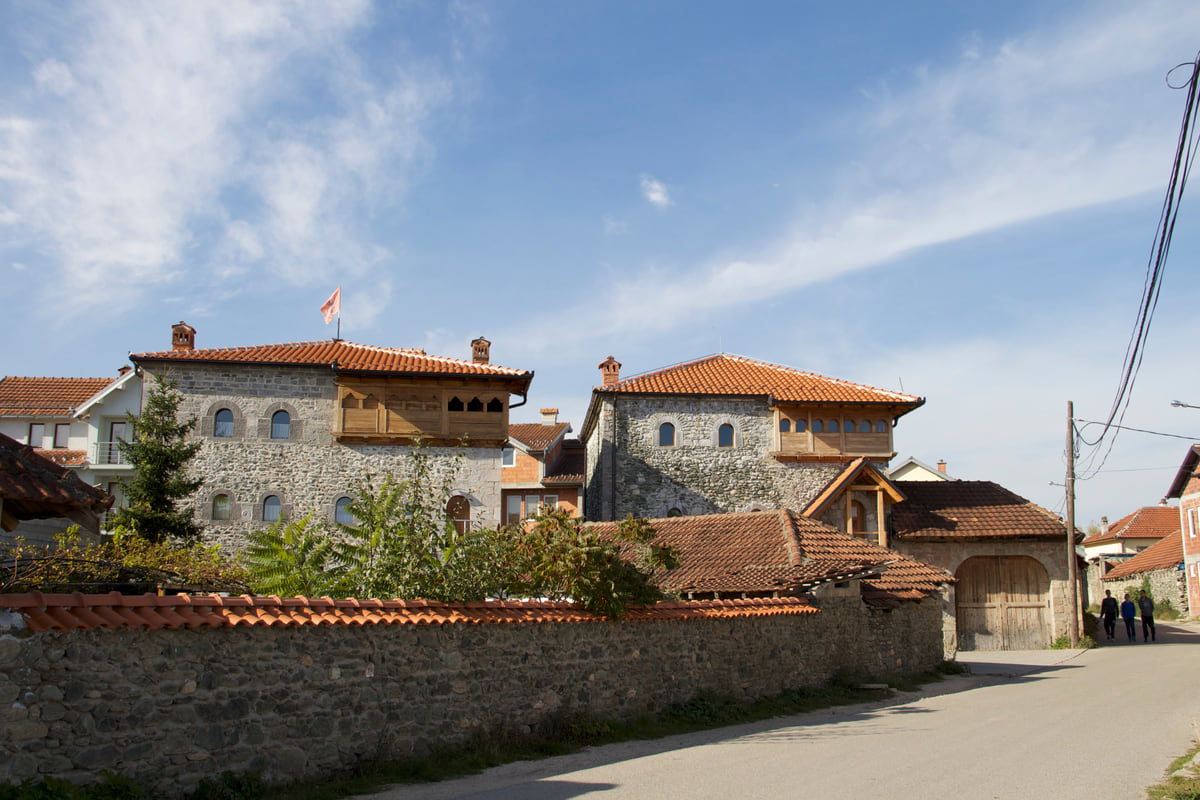 The kulla of Brahim Hoxha in Junik, a stone tower house of several storeys beside a village street