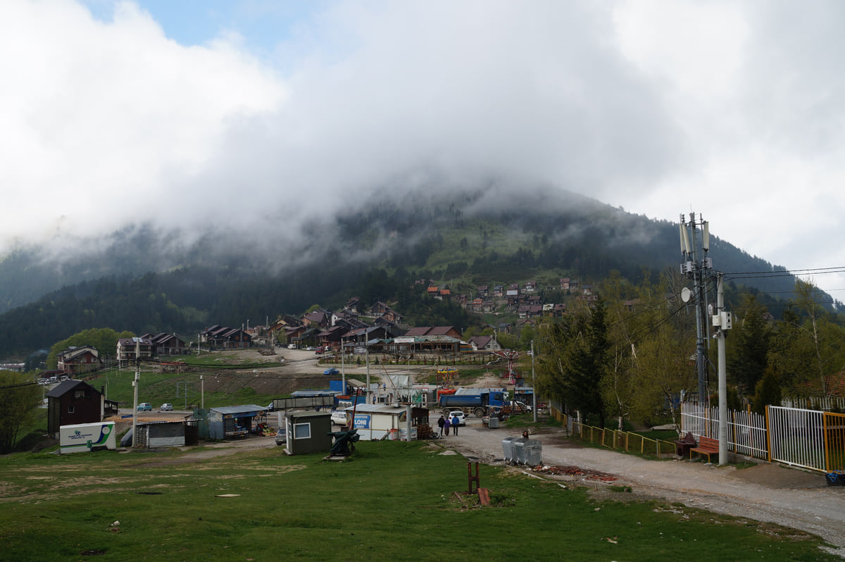 The mountain pass and hamlet of Prevalla in the Sharr mountains, with houses and meadows below a wooded slope