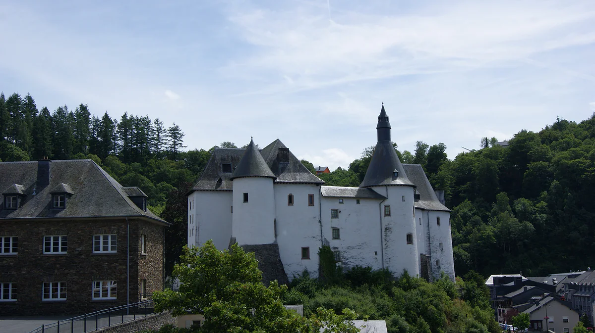 The white castle of Clervaux, home of The Family of Man exhibition, among village houses and wooded hills
