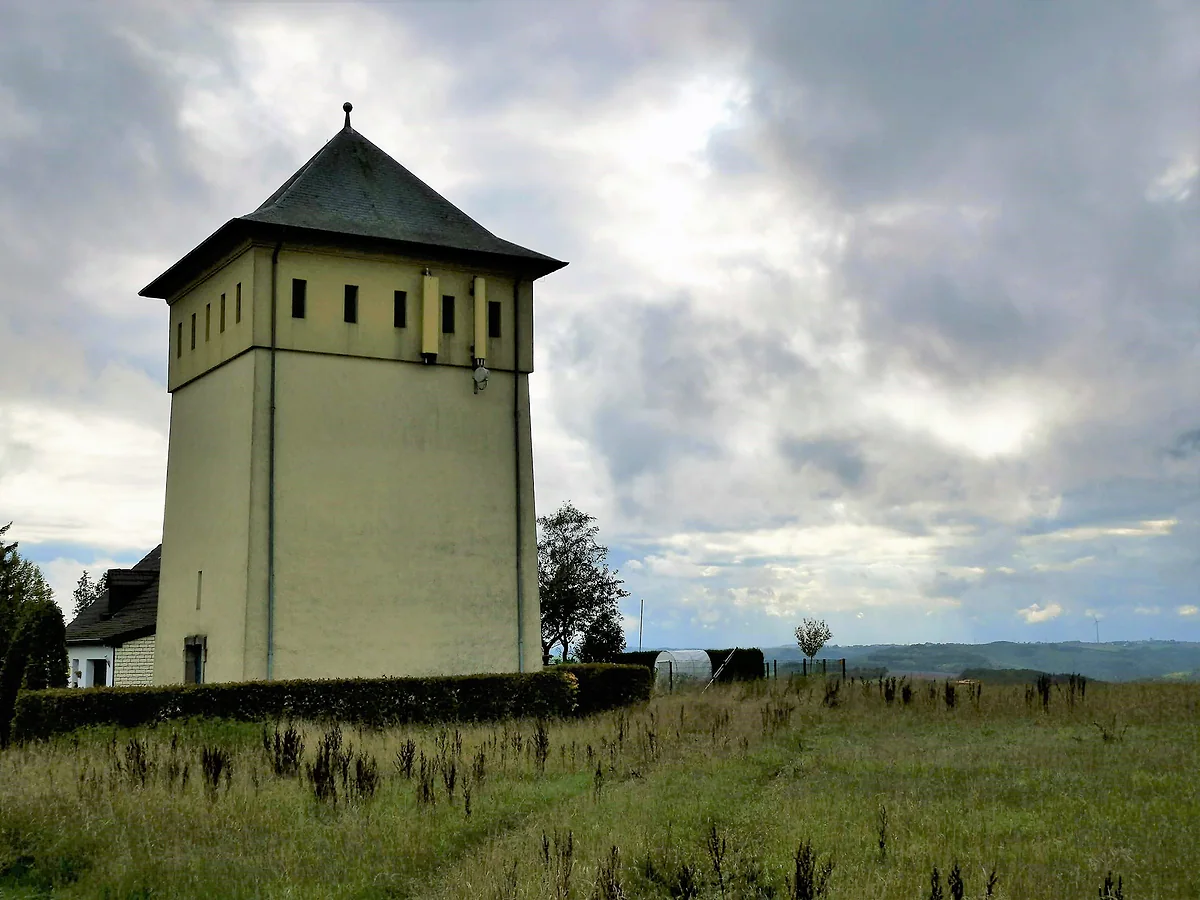 The water tower at Hoscheid, in Parc Hosingen, a square slate-roofed tower on the Éislek plateau
