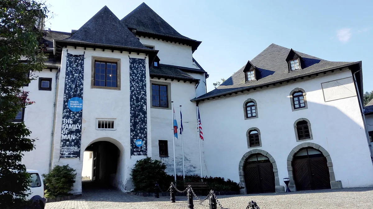The entrance to Clervaux Castle, home of The Family of Man, with exhibition banners on the white façade