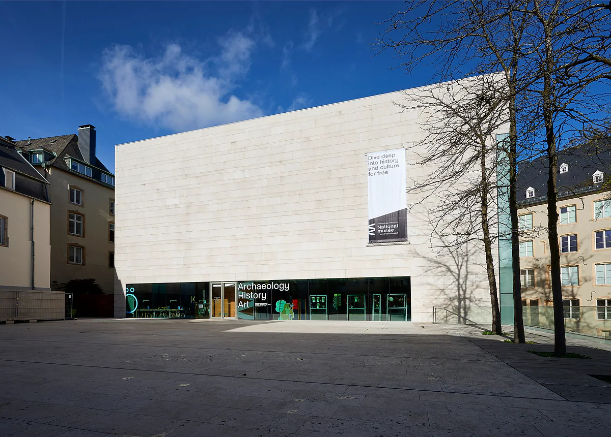 The pale stone building of the National Museum of Archaeology, History and Art on the Marché-aux-Poissons