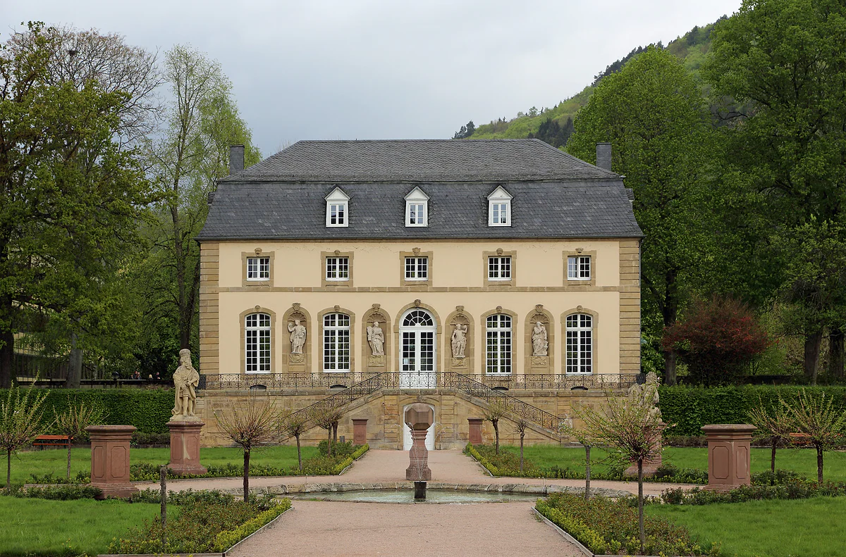 The orangery of the former abbey at Echternach, a Baroque pavilion with statues and a formal garden in front