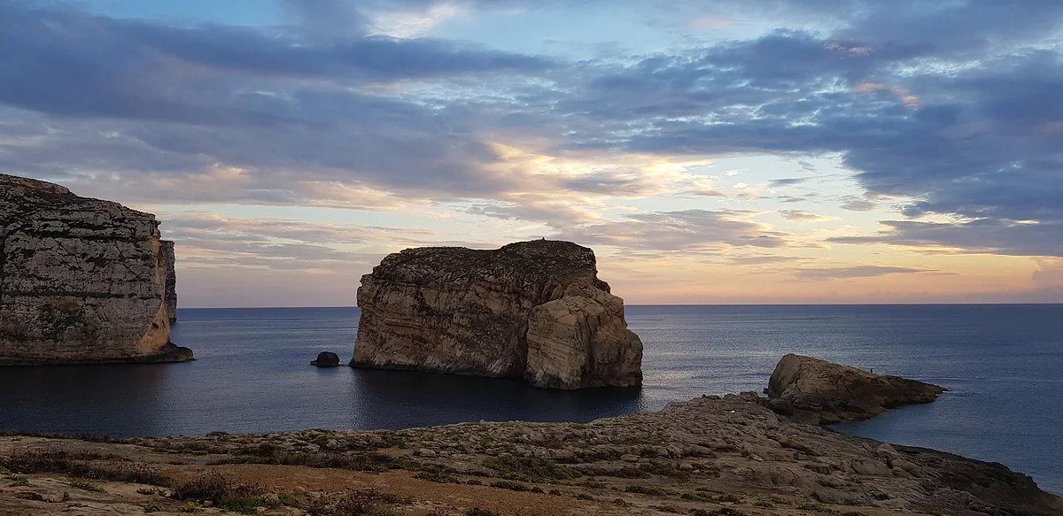 Fungus Rock al atardecer en la bahía de Dwejra, en Gozo, el islote de roca junto a la costa donde estuvo la Azure Window hasta 2017.