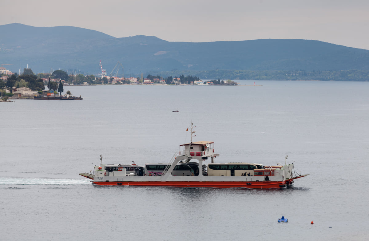 The ferry crossing the Verige strait between Kamenari and Lepetane in the Bay of Kotor, with the shore behind